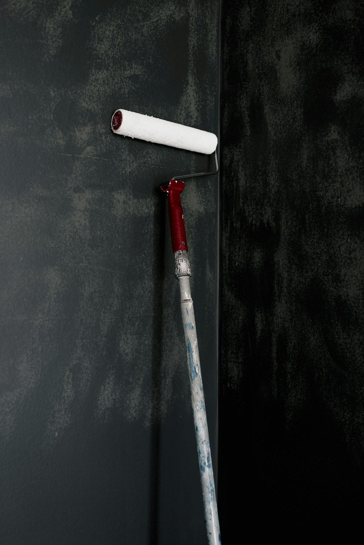 A paint roller applying a fresh coat to an interior wall